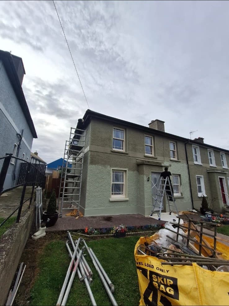Exterior house painting — scaffolding up, work underway