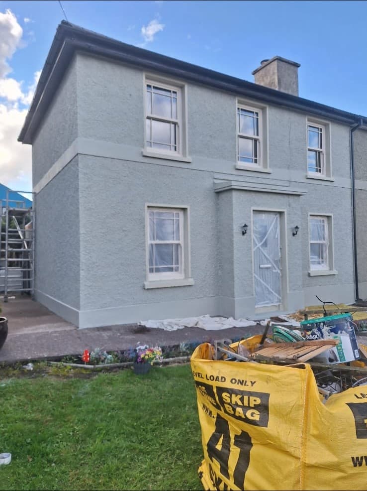 Exterior house painting completed — fresh render finish